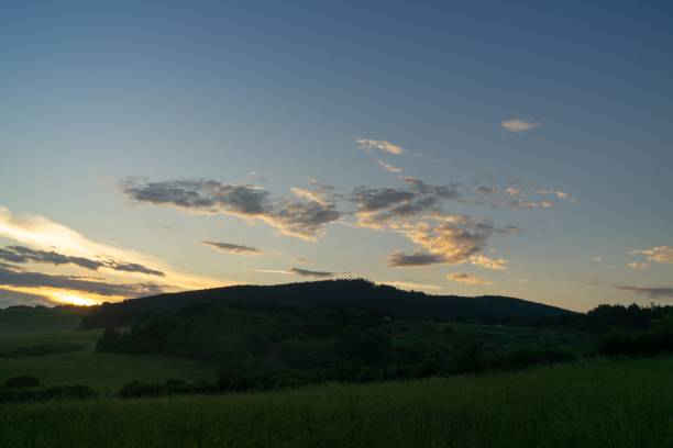 istock Sunrise or sunset over the hills and meadow. 1215770840