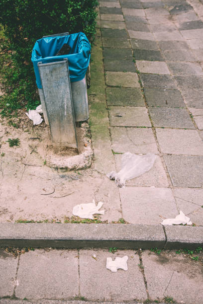 istock rubbish bucket with protective gloves 1215771864