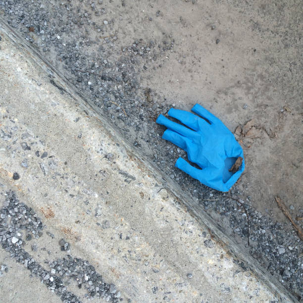 istock Disposable Protective Blue Glove on the Ground 1215771989