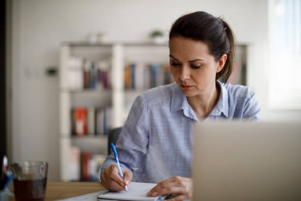 istock Mature woman working from home during COVID-19 pandemic 1215772476