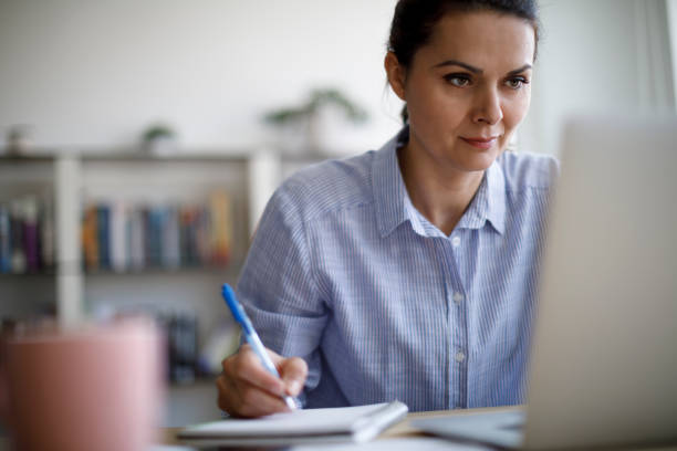 istock Mature woman working from home during COVID-19 pandemic 1215772487