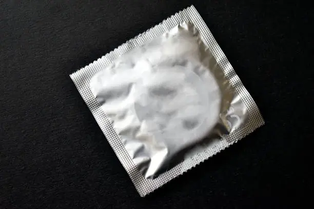 Photo of Just an ordinary condom on a black background