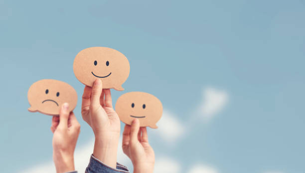 istock Customer showing rating with happy icon on sky background, Customer satisfaction survey concept. 1215775071