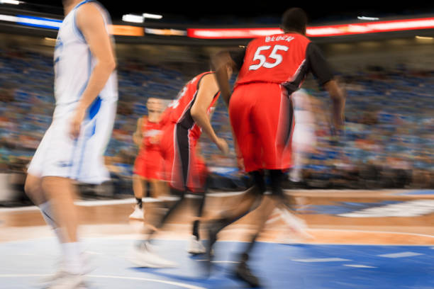 Blurred motion of basketball players playing on court in Arena Stozice, Ljubljana, Slovenia.