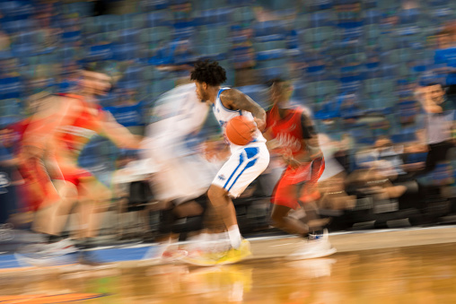Blurred motion of basketball players tackling for ball during the match in Arena Stozice, Ljubljana, Slovenia.