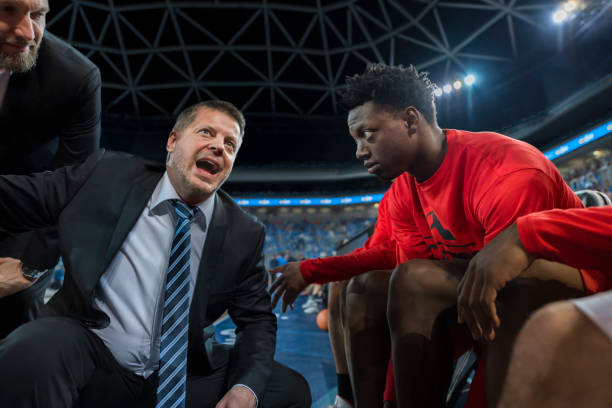 istock Coach giving instructions to basketball team 1215776264
