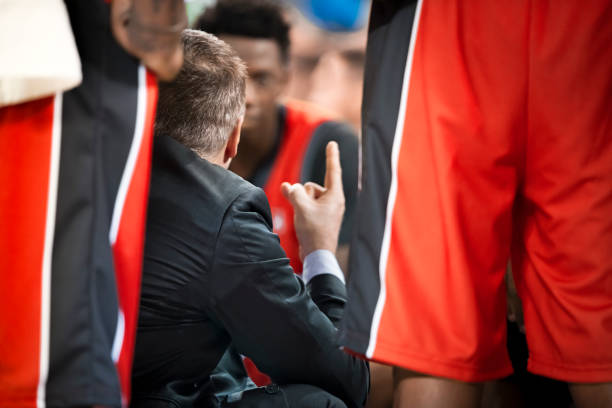 istock Coach giving instructions to basketball team 1215776288