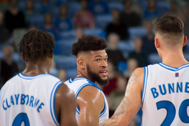 Basketball players talking on court