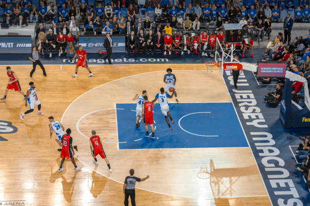 istock Basketball players tackling for ball 1215776302