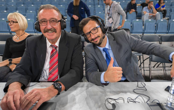 Basketball commentators wearing headphones