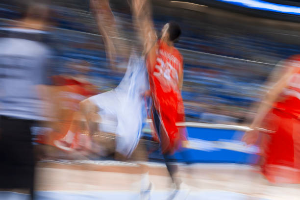 Blurred motion of basketball players tackling for ball during the match in Arena Stozice, Ljubljana, Slovenia.
