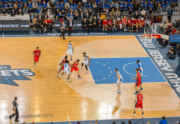 Basketball players tackling for ball Elevated view of basketball players tackling for ball during the match at Arena Stozice, Ljubljana, Slovenia. woman tackled at basketball game stock pictures, royalty-free photos & images