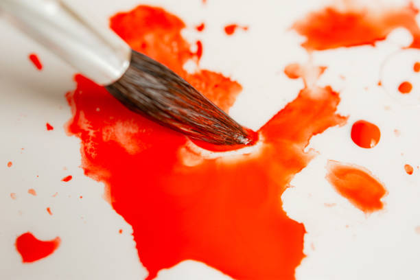 istock Watercolor brushes and red paint top view. 1215776679