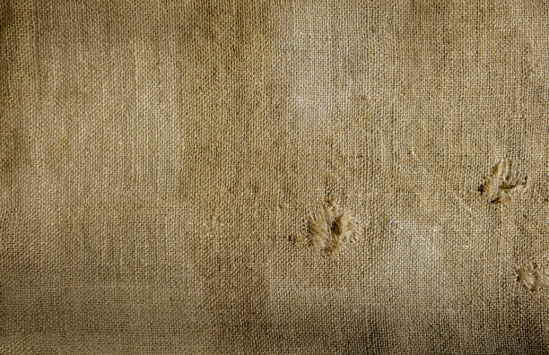 istock Background made of natural rustic burlap with two holes. 1215778384