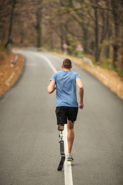 istock Young male with prosthetic leg working out outdoor 1215778419
