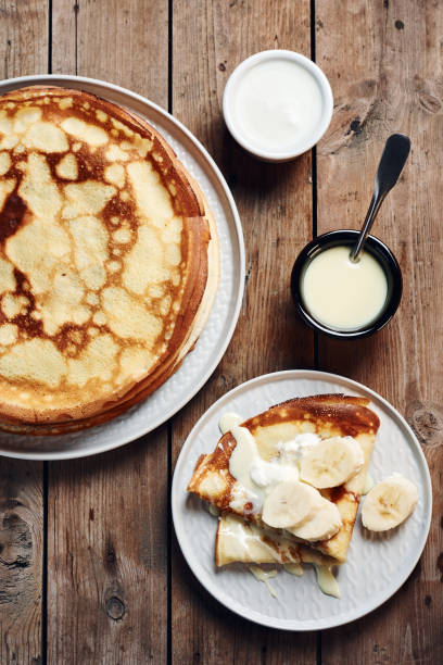 istock Thin pancakes, crepes with bananas and condensed milk. 1215779081