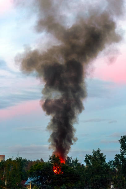 istock the building burns with fire and black smoke against the evening sky 1215779134