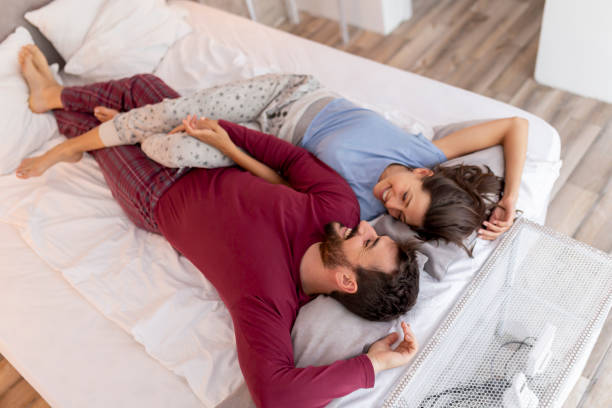 istock Couple in love cuddling in bed 1215779987