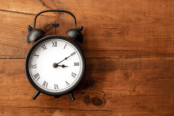 istock Clock wooden background. Alarm. Hurry up. Rush. Time. Little time 1215780675