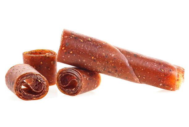 istock Fruit pastille isolated on a white background. Fruit roll-ups made from raspberry, apples and currant. 1215784253