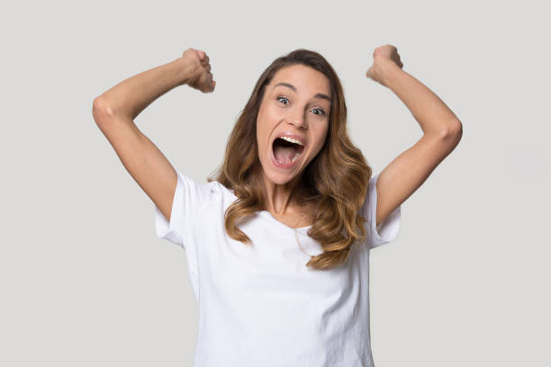 istock Happy excited woman celebrating win, raising hands, shouting 1215784437