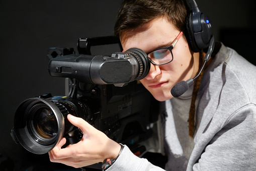 Cameraman using professional digital video camera.