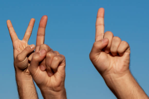 istock Childrens hands and fingers in the sky 1215787882
