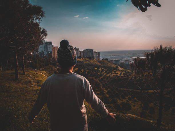 istock A man between the mysterious city and the forest. 1215788287
