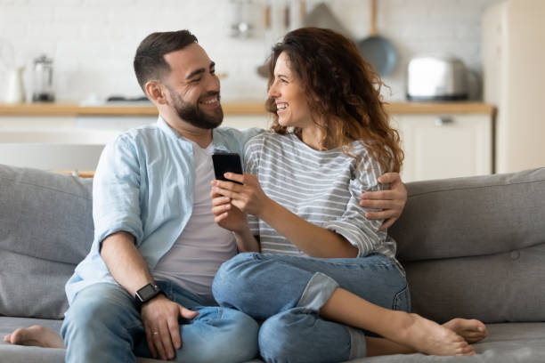 istock Happy couple have fun using cellphone together 1215789526