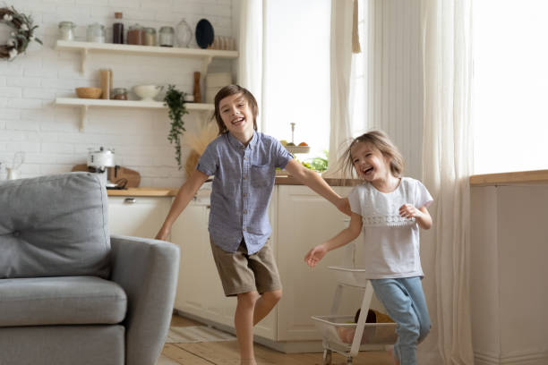 Overjoyed siblings have fun racing at home