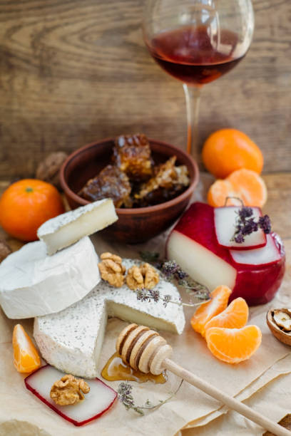 istock Red Wine and camembert, brie, gouda cheese served on the table 1215790675