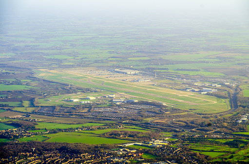 Aerial view of Stansted Airport and its landing strip in a misty day