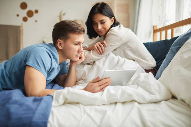 istock Couple Ordering Online Services in Bedroom 1215795089