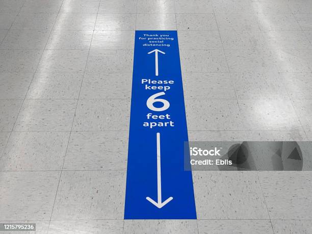 Social Distancing Floor Sign Warning About Safe Distance Between People Of 6 Feet Public Health Measure To Prevent Further Spread Of New Corona Virus Covid19 Infections Stock Photo - Download Image Now