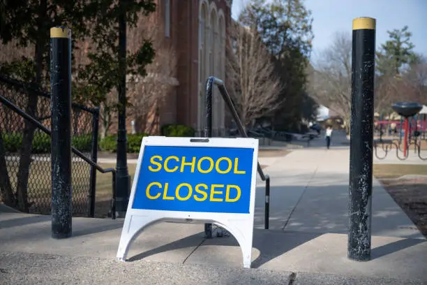 A "closed" sign in front of a public elementary school in Grand Rapids, Michigan in March 2020. Michigan closed all schools in an effort to thwart the spread of the novel coronavirus.