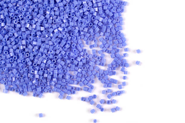 istock A scattering of blue matte beads on a white background 1215796768