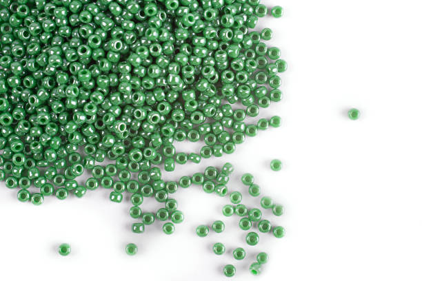 istock A scattering of green beads on a white isolated background 1215797038