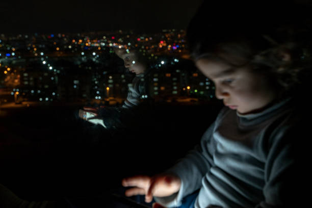 istock Boy playing with phone at home 1215798440