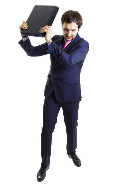 istock Angry businessman throwing a laptop 1215798464