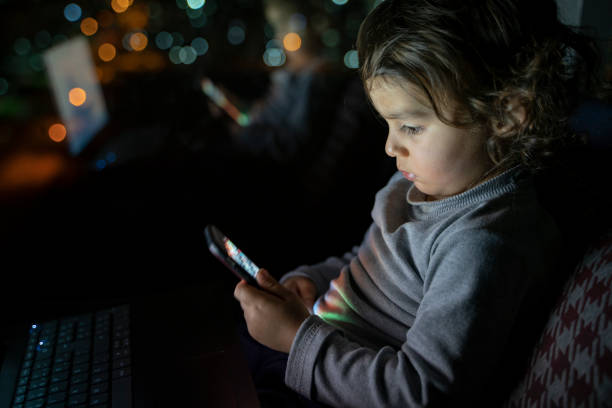 istock Boy playing with phone at home 1215798719