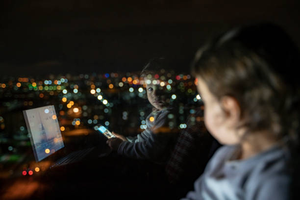 istock Boy playing with phone and laptop at home 1215798721