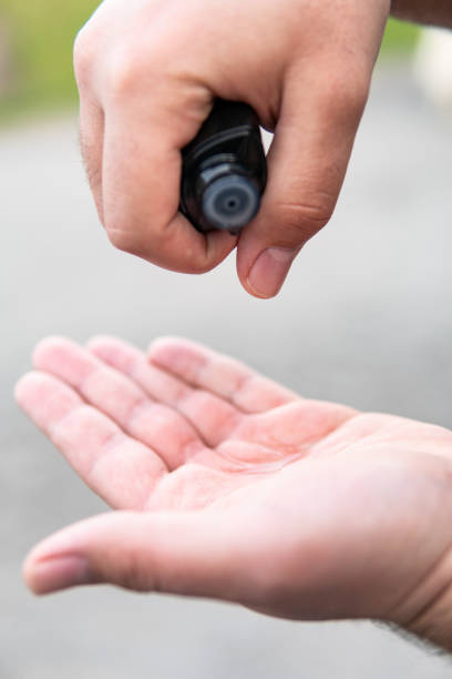 istock Disinfecting male hands with disinfectant 1215800175