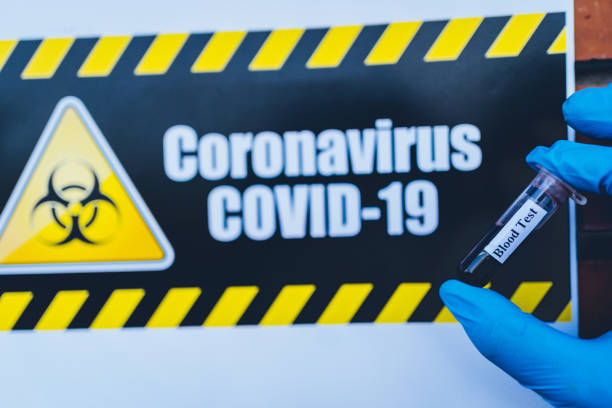 istock Coronavirus warning sign and blood sample that has tested for Coronavirus 1215802707