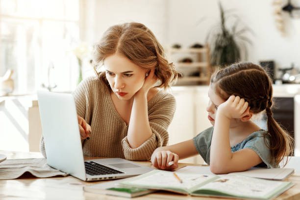 istock Mother helping daughter with homework 1215803568