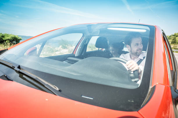istock Caucasian man driving a car during summer holiday 1215803697