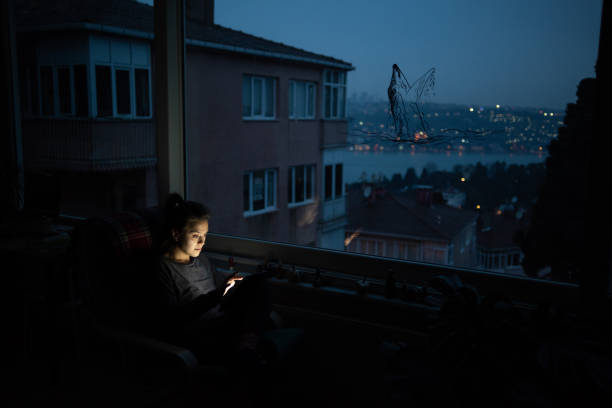 istock Young woman look her screen front of window 1215803823