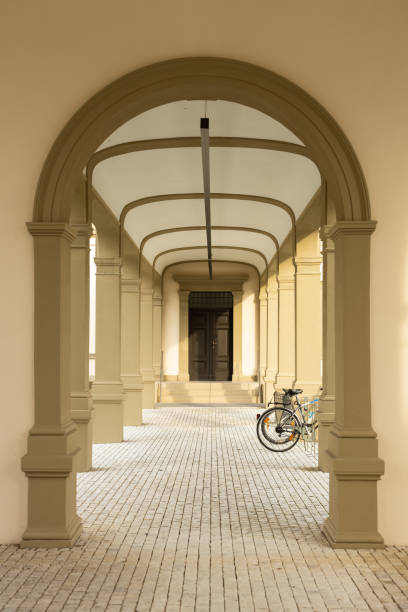 Beautiful walkway. Beige arch with bicycle on background