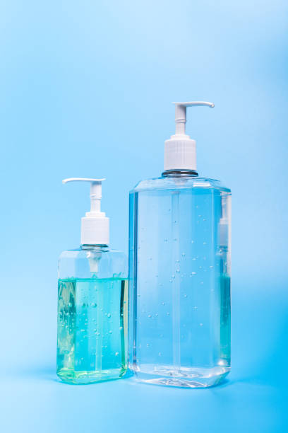istock Two hand sanitizer in plastic bottle on blue background 1215805096