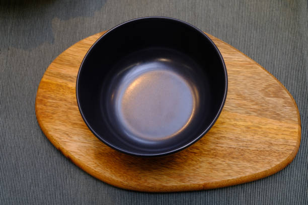 istock metal bowl on a wood mat 1215810174