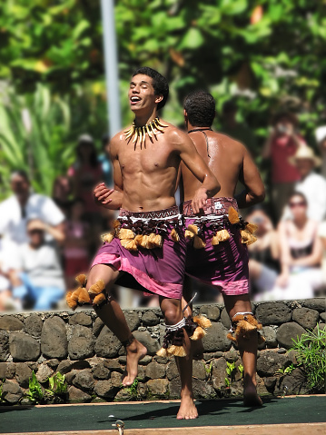 Oahu, HI, USA - August 16, 2007: Samoa men perform traditional dance on a canoe. Traditional performances such as these, are a mainstay of the Hawai'ian tourism industry.